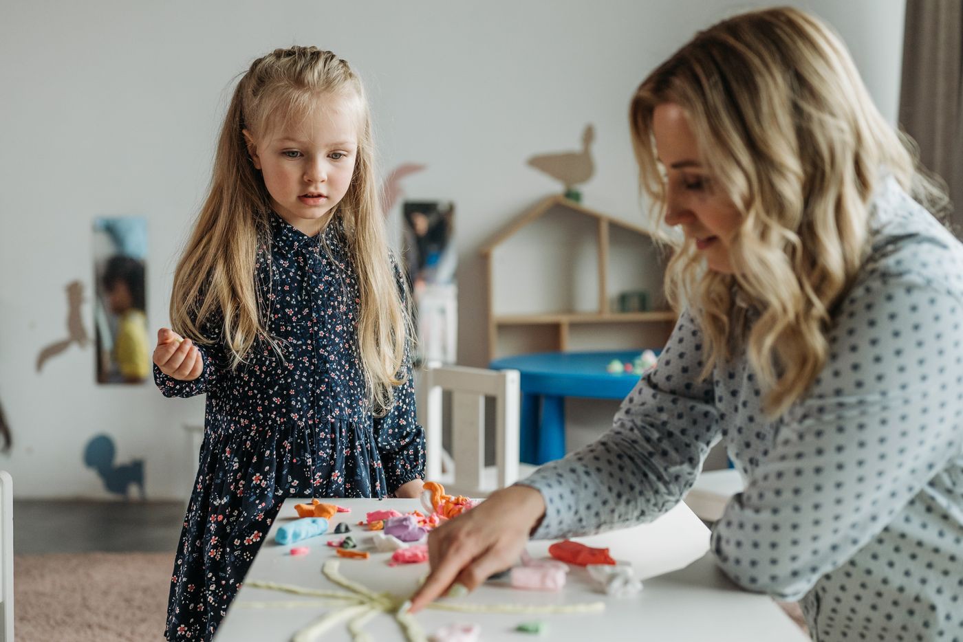 Adult supporting a pupil with a table-top activity